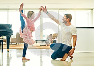 Youve got this. Full length shot of a mature man helping his daughter practice for her ballet recital.