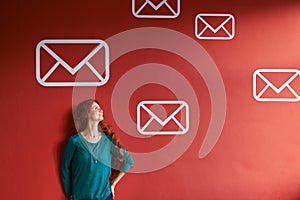 Youve got mail. a young woman surrounded by messaging graphics on a red background.