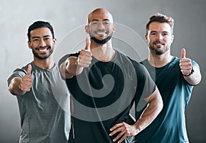 Youve got our support. Cropped portrait of three handsome young male athletes giving thumbs up towards the camera