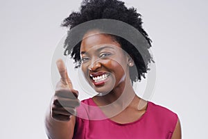 Youve impressed me. Studio portrait of an attractive young woman giving a thumbs up against a grey background.