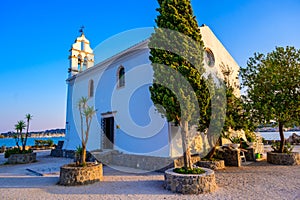 Ypapanti Church - Beautiful scenery at sunset in Gouvia Bay Ã¢â¬â small ancient white church on a pier, Corfu island, Ionian sea,