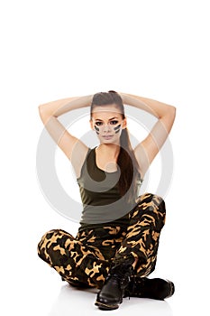 Ypung beautiful soldier woman sitting on the floor