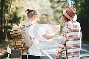 Ypung hipster couple hiking on forest road