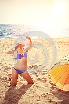 YSummer holiday, girl traveling, relax on the beach on a background of water. Fun summer party in the trip. Woman on