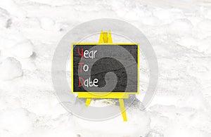 YTD year to date symbol. Concept words YTD year to date on beautiful yellow blackboard. Beautiful white snow background. Business photo