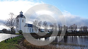 Ytterhogdalen church at the kyrksjÃ¶n lake in autumn in Harjedalen in Sweden