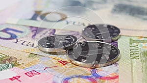 Yuan bank notes and coins rotating business background