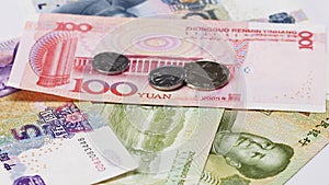 Yuan bank notes and coins rotating business background