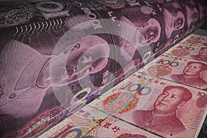Yuan banknote money printing process. Bank press machine to print money. Concept of economic situation in China and the world