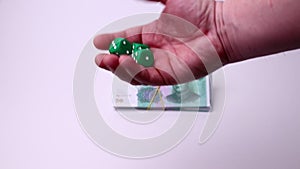 Yuan Chinese currency and dice isolated on a white background. Studio footage, non edited.
