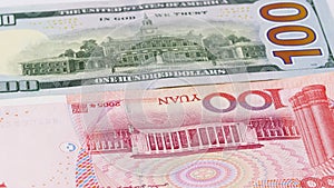 Yuan vs Dollar bank notes rotating concept business background