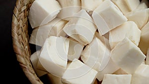 Yuca Cassava root raw slices in rustic bowl.