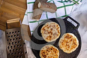 Yucca chunks and bread on budare