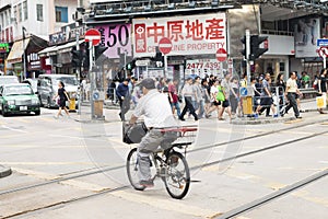 Yuen Long, Hong Kong- October 7, 2016: People crossing road and rail on foot and on bike at Yuen Long train station