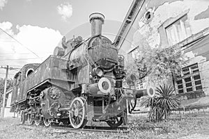 Yugoslavian locomotive near old rail station, black and white