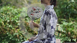 Yukata woman fanning with a fan