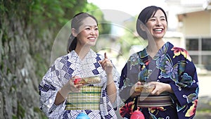 Yukata woman walking with yo-yo and fried noodles