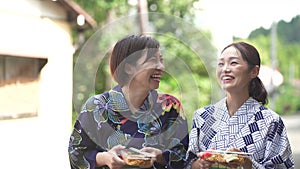 Yukata woman walking with yo-yo and fried noodles