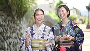 Yukata woman walking with yo-yo and fried noodles