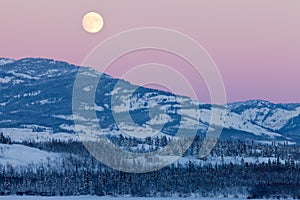 Yukon Canada winter landscape and full moon rising