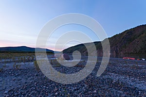 Yukon midsummer night tent camp and beached canoes photo