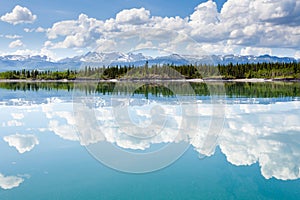 Yukon wilderness cloudscape reflected on calm lake