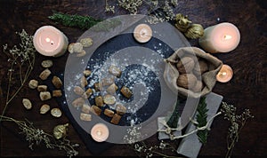 Yule winter solstice Christmas kitchen witchery. Preparation of festive food on dark wooden table.