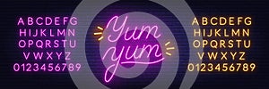 Yum Neon Sign on brick wall background.