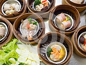 Yumcha or Dimsum, various chinese cuisine steamed dumpling in bamboo basket steamer in chinese restaurant