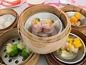 Yumcha, various chinese steamed dumpling in bamboo steamer in chinese restaurant. Dimsum in the steam basket, Chinese food