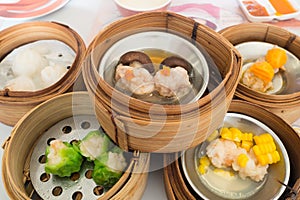 Yumcha, various chinese steamed dumpling in bamboo steamer in chinese restaurant. Dimsum in the steam basket, Chinese food