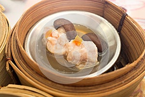 Yumcha, various chinese steamed dumpling in bamboo steamer in chinese restaurant. Dimsum in the steam basket, Hong kong local food