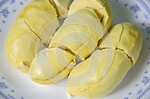 Yummy aril of durian fruit in white dish close up