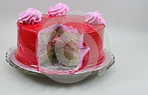 Yummy cut strawberry birthday cake isolated on white background
