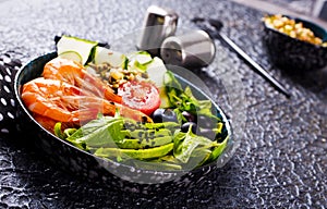 Yummy salad with fried shrimps, arugula, avocado and cucumber