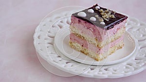 Yummy slice of strawberry cake on pink background, creamy dessert