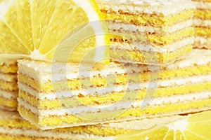 Yummy and sweet dessert. Waffles with milk and lemon filling. Tasty food. Lemon slices. Wafers lying on each other. Bun