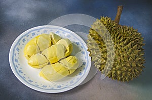 Yummy yellow aril of durian in white dish and fruit