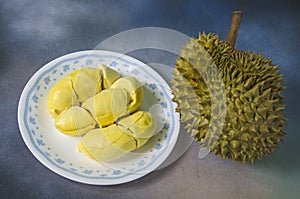 Yummy yellow aril of durian in white dish and fruit photo