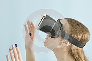 Yuong woman with glasses of virtual reality. Blue background