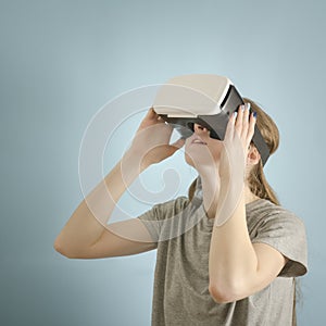 Yuong woman with glasses of virtual reality. Blue background