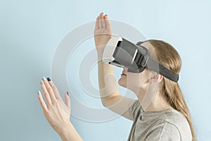 Yuong woman with glasses of virtual reality. Blue background