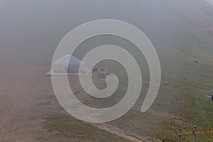 Yurt in a mist in Trans-Ili Alatau Zailiyskiy Alatau mountain range near Almaty, Kazakhst