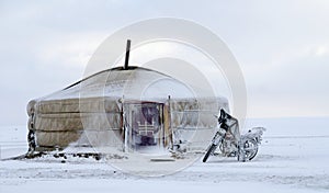 Yurt in the snow with a motorcycle in mongolia