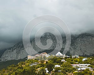 Yusupov Palace in Koreiz with clouds covering the peaks of the mountains in the background