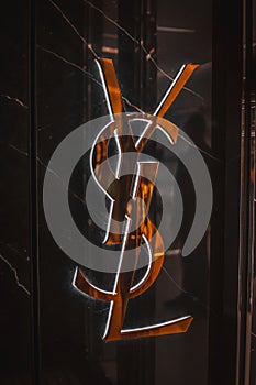 Yves Saint Laurent shop text sign and logo brand on wall entrance facade chain fashion house fashion district Via