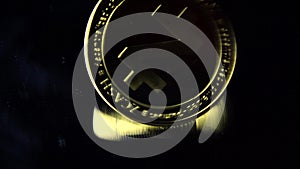 Z-cash gold coin spins on a black mirror surface 01