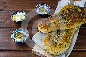 Za`atar bread, a lebanese or turkish or arabic bread made with sumac, sesame  seeds  olive oil served with labneh or labane on top