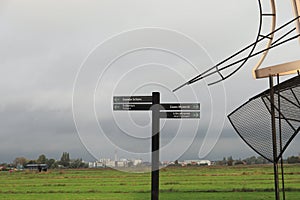 Zaanse Schans at dawn - signboard - Windmills - fields and meadows - Netherlands country side - Holland tourism
