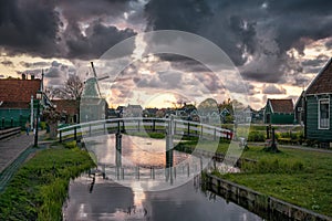 Zaanse Schans windmill landscape in the Netherlands, sunset cloudy sky